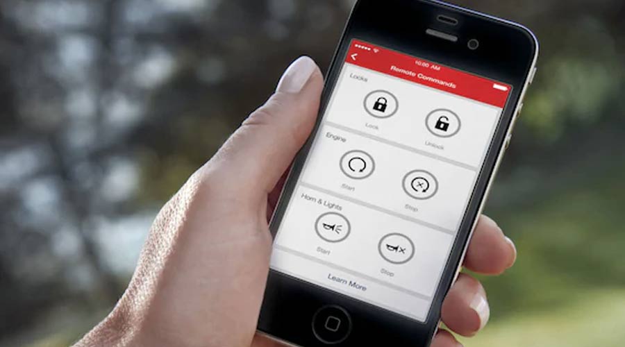 A hand holding a phone displaying the My GM Rewards app